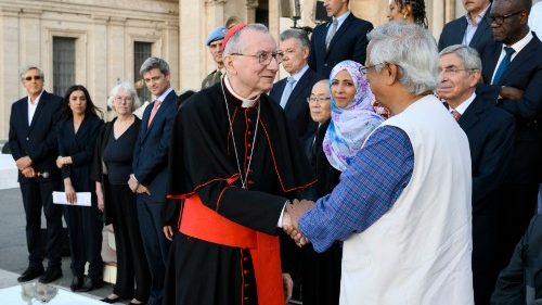 Muhammad Yunus, right, shakes hands with Vatican Secretary of State Cardinal Pietro Parolin at the signing of the Declaration on Human Fraternity