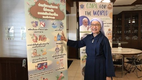 Sr. Agnes Kanlaya Trisopa points to a poster about her waste separation management program