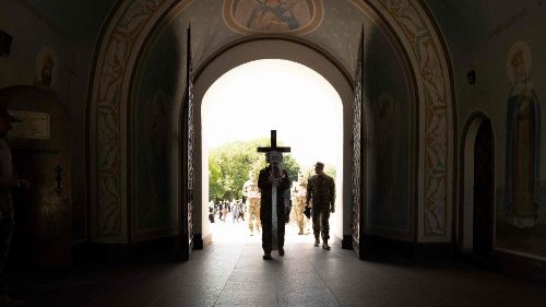 Ukrainian servicemen carry a cross during a funeral for a fallen Air Force colonel