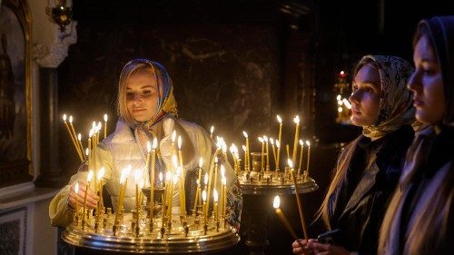 Orthodox believers light candles at St Volodomyr Cathedral in Kyiv ahead of the Divine Liturgy for Easter