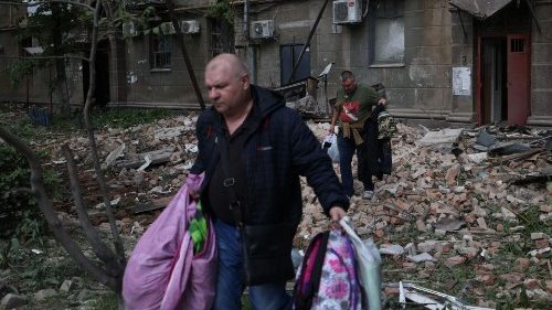 Local residents take their belongings out of damaged buildings after a missile attack, Dnipro