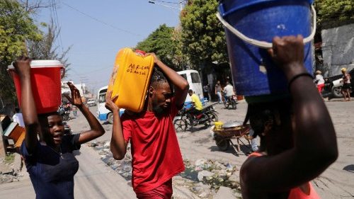 After the prime minister pledged to step down, an uneasy quiet in Haiti capital