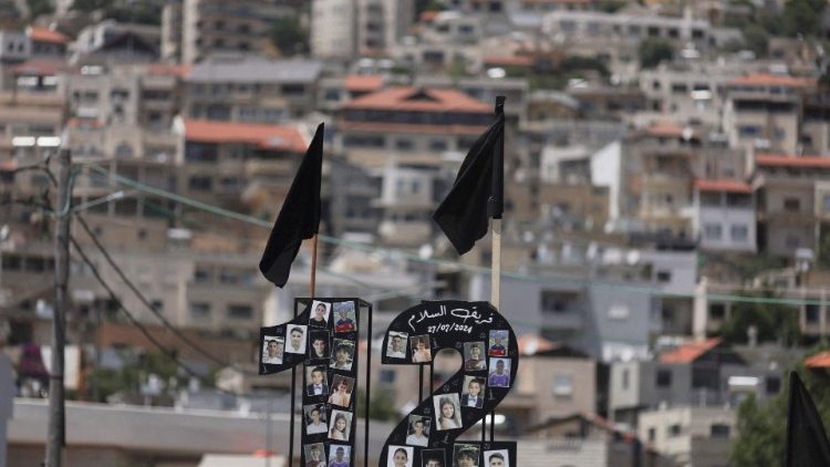 Pictures of children and black flags are displayed, after children and teens were killed at a soccer pitch by a rocket, near Majdal Shams